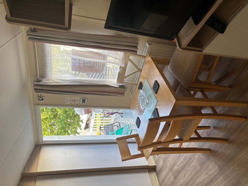 A dining area with a table and chairs at a location