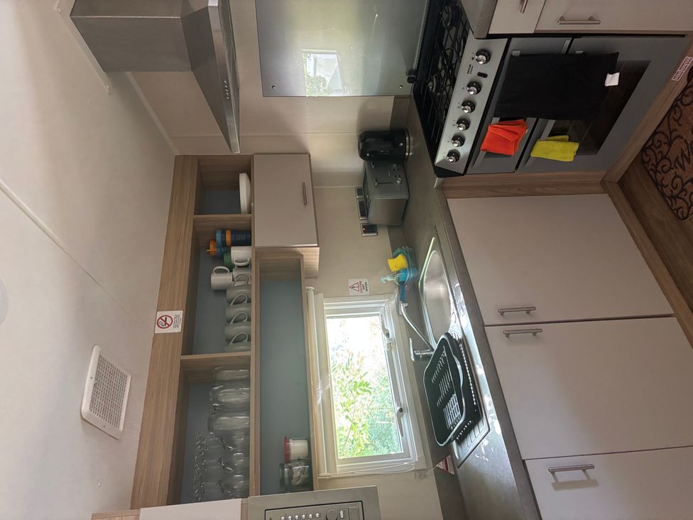 A kitchen with sink and gas stove at The Old Barn in Manchester