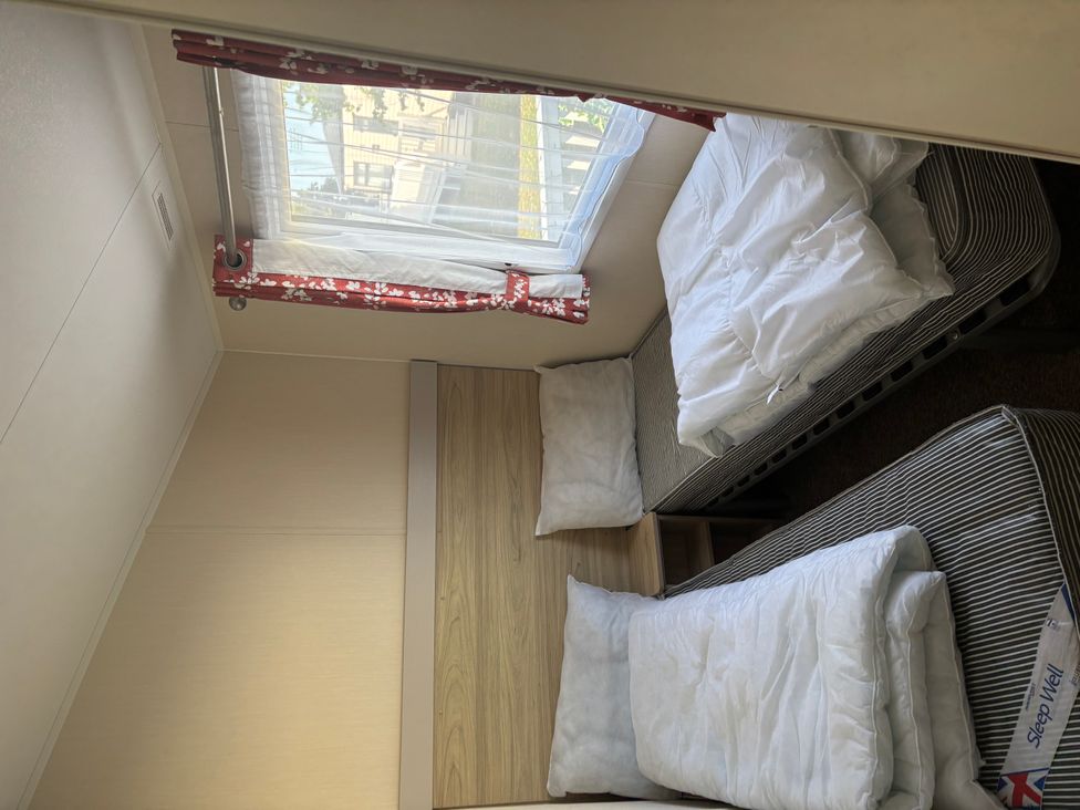 A bedroom with two beds and a window at 