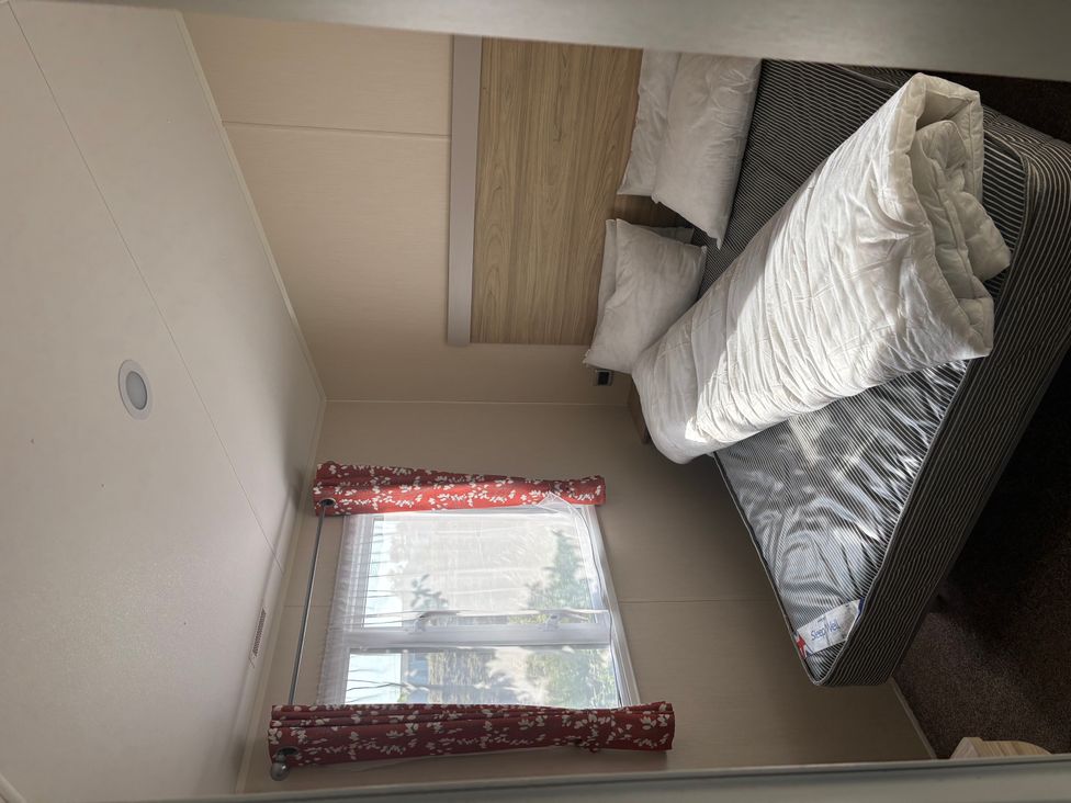 A bedroom with a bed and window at an unspecified location