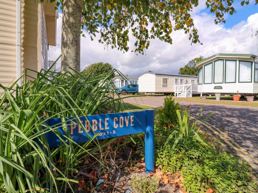 A sign for Pebble Cove at Singh and Leite Family Caravan St. Osyth