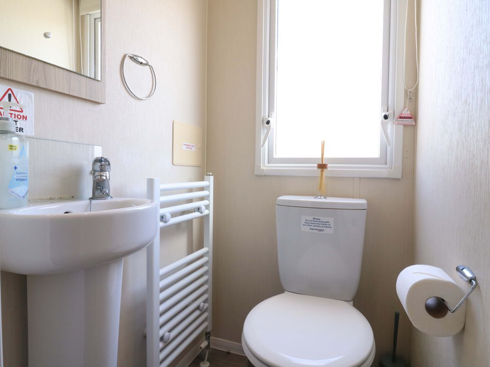 A bathroom with a sink and toilet at Singh and Leite Family Caravan St. Osyth