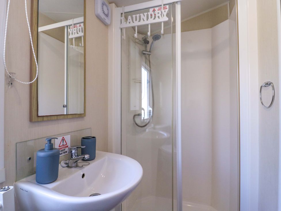 A bathroom with a sink and shower at Singh and Leite Family Caravan St. Osyth