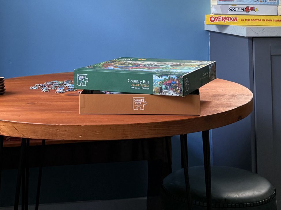 A table with a jigsaw puzzle box and pieces at Portknockie Cottage Buckie