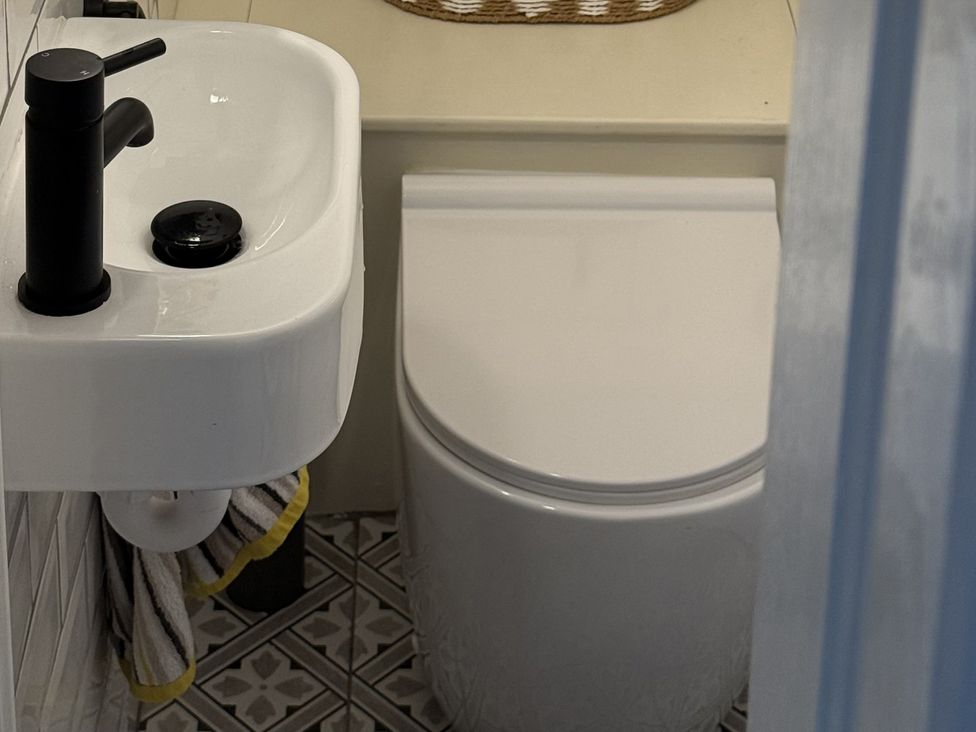 A bathroom with a sink and toilet at Portknockie Cottage Buckie