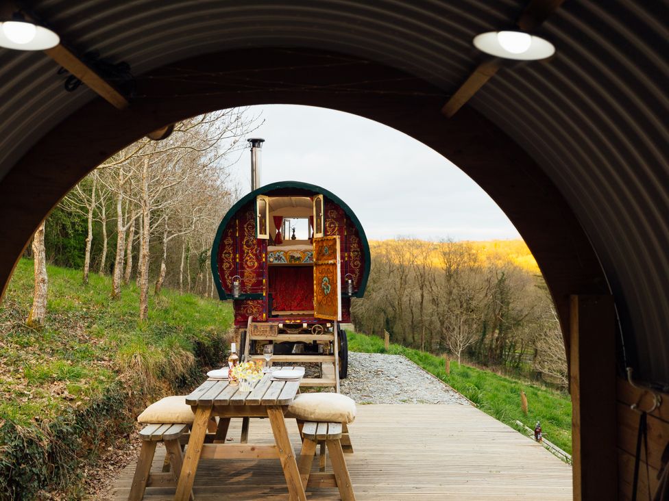 An outdoor area with a dining table and wagon at Goldfinch Launceston