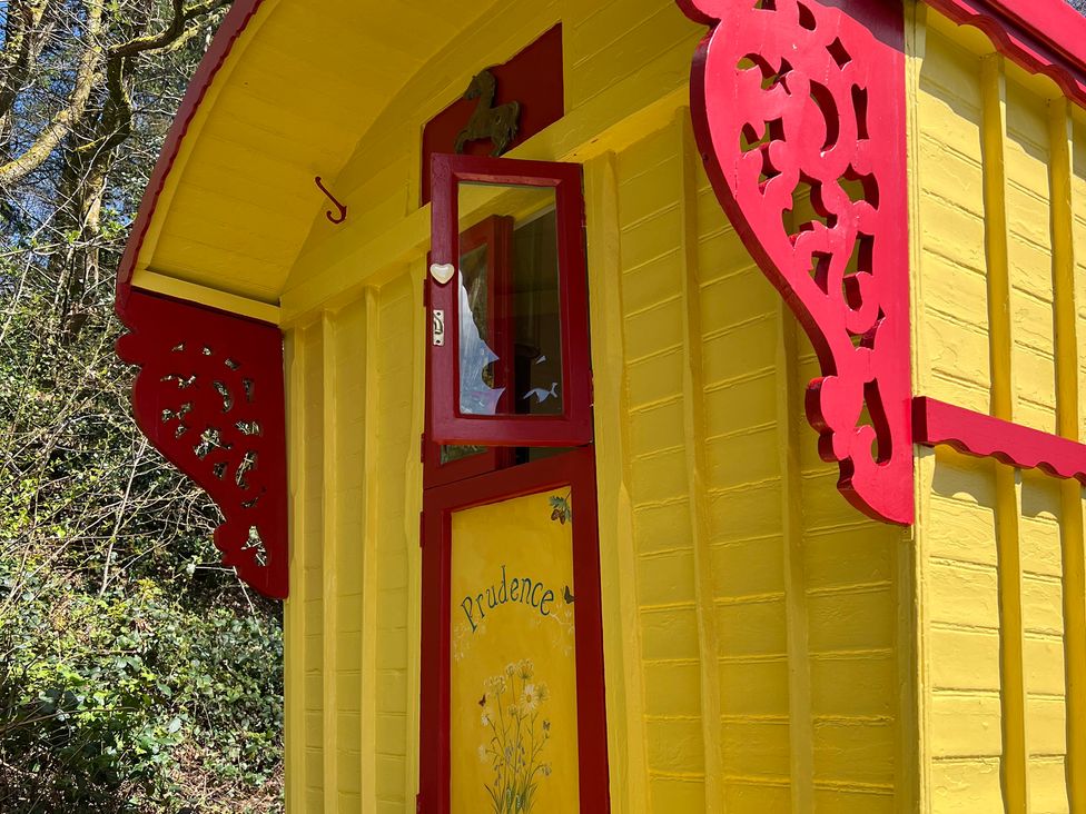 A yellow structure with red trim and decorative details at Prudence in Launceston