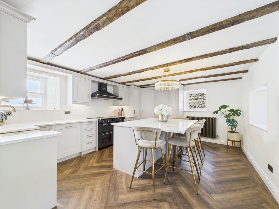 A kitchen with cabinets and an island at 17C King Street Barnard Castle