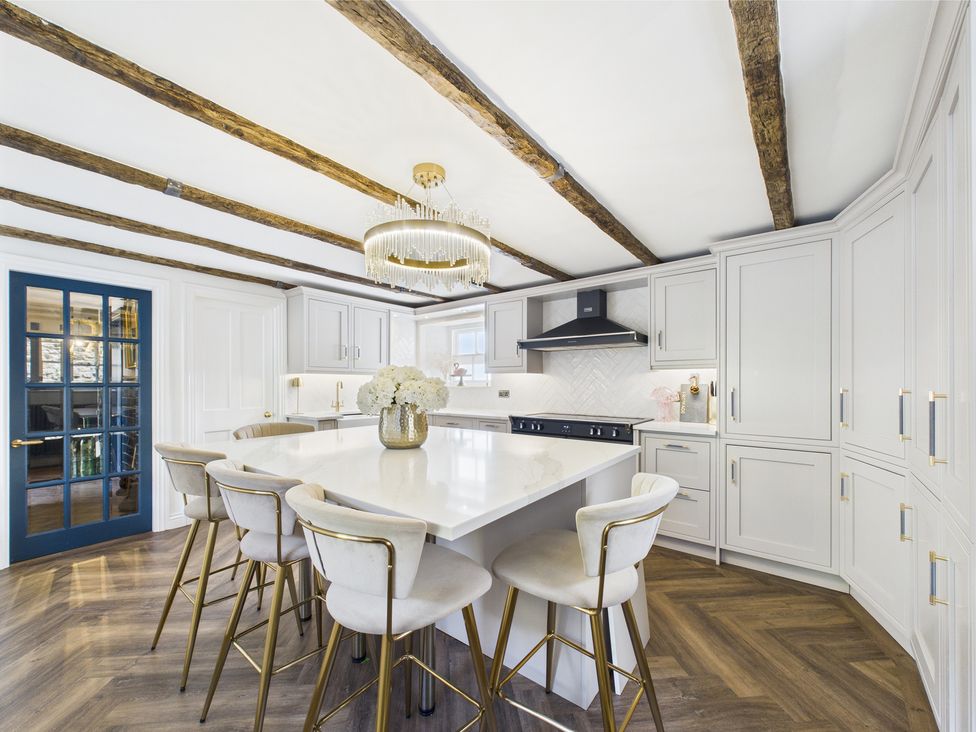 A kitchen with an island and bar stools at 17C King Street Barnard Castle