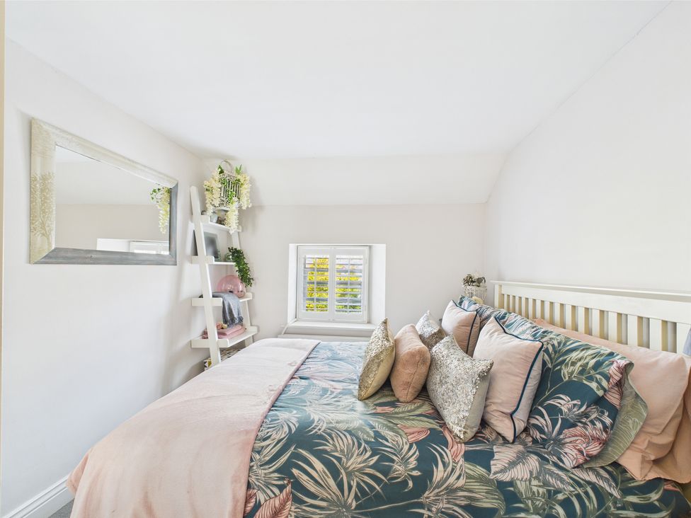 A bedroom with a bed and decorative pillows at 17C King Street Barnard Castle