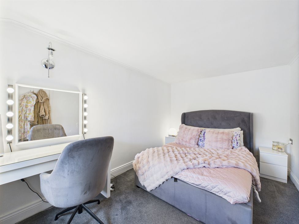 A bedroom with a bed and vanity at 17C King Street Barnard Castle