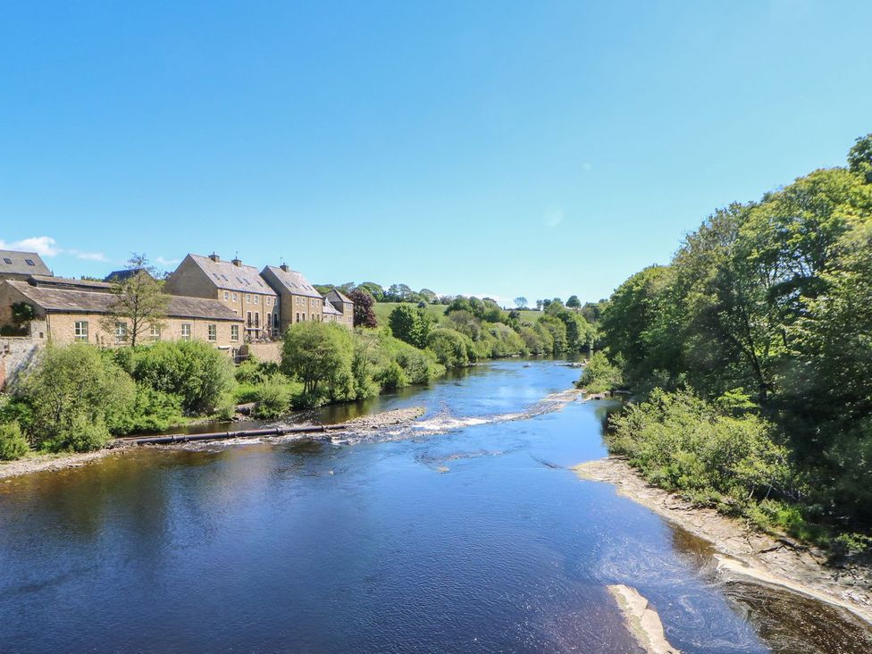 A view of a river with houses and trees in the background at 17C King Street Barnard Castle