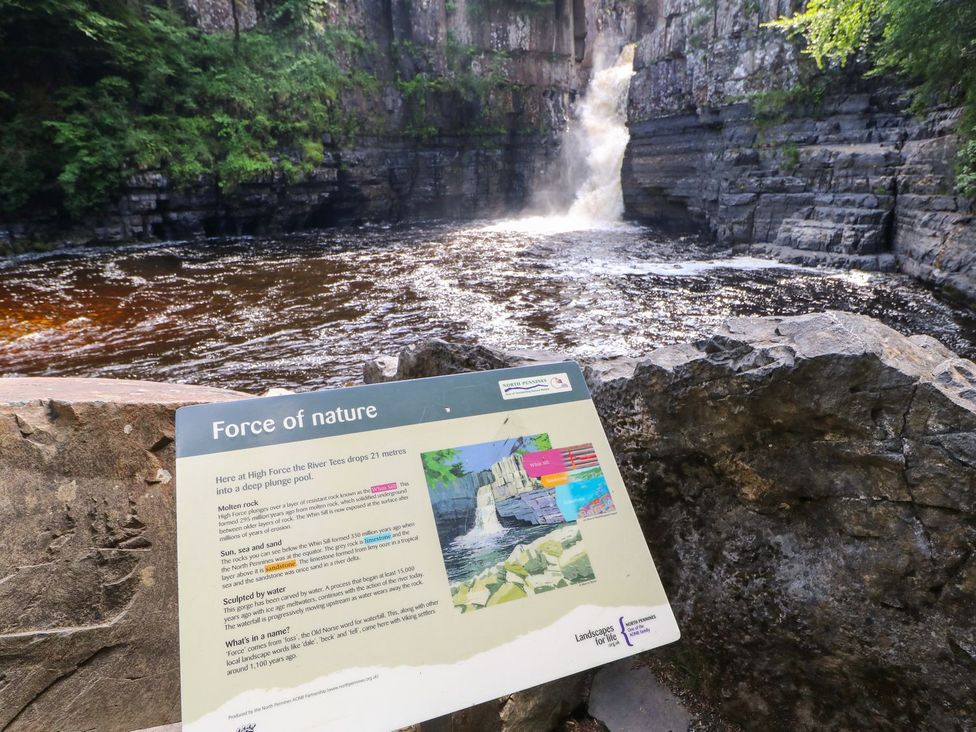 A waterfall with an information sign at High Force in Barnard Castle