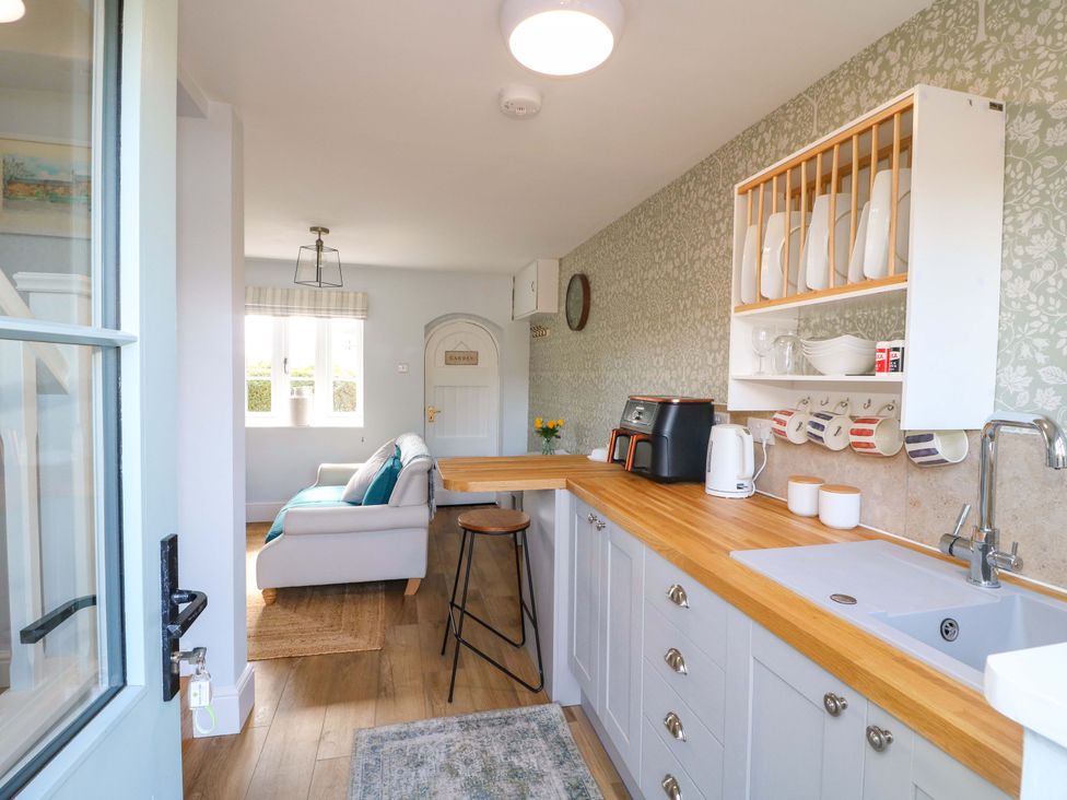A kitchen with a countertop and seating area at Prospect Cottage in 