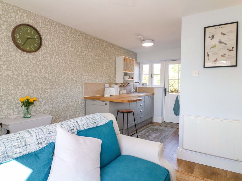 A kitchen with a round table and chairs at Prospect Cottage