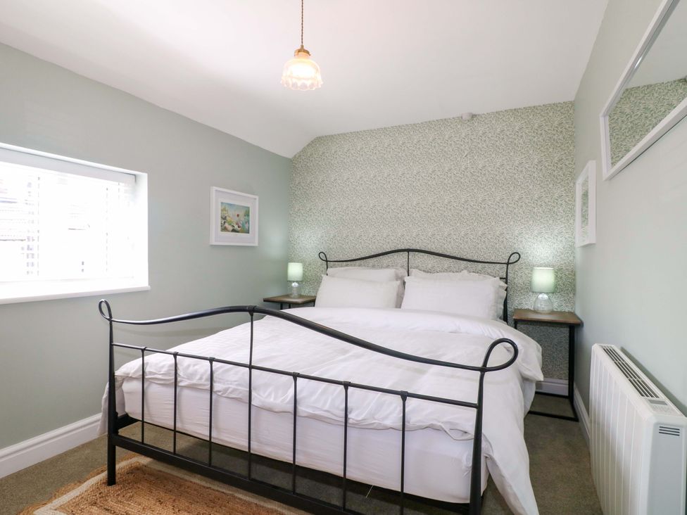 A bedroom with a bed and bedside table at Prospect Cottage