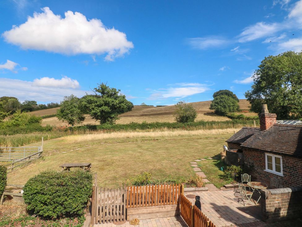 A garden view with cottage and fields at Prospect Cottage