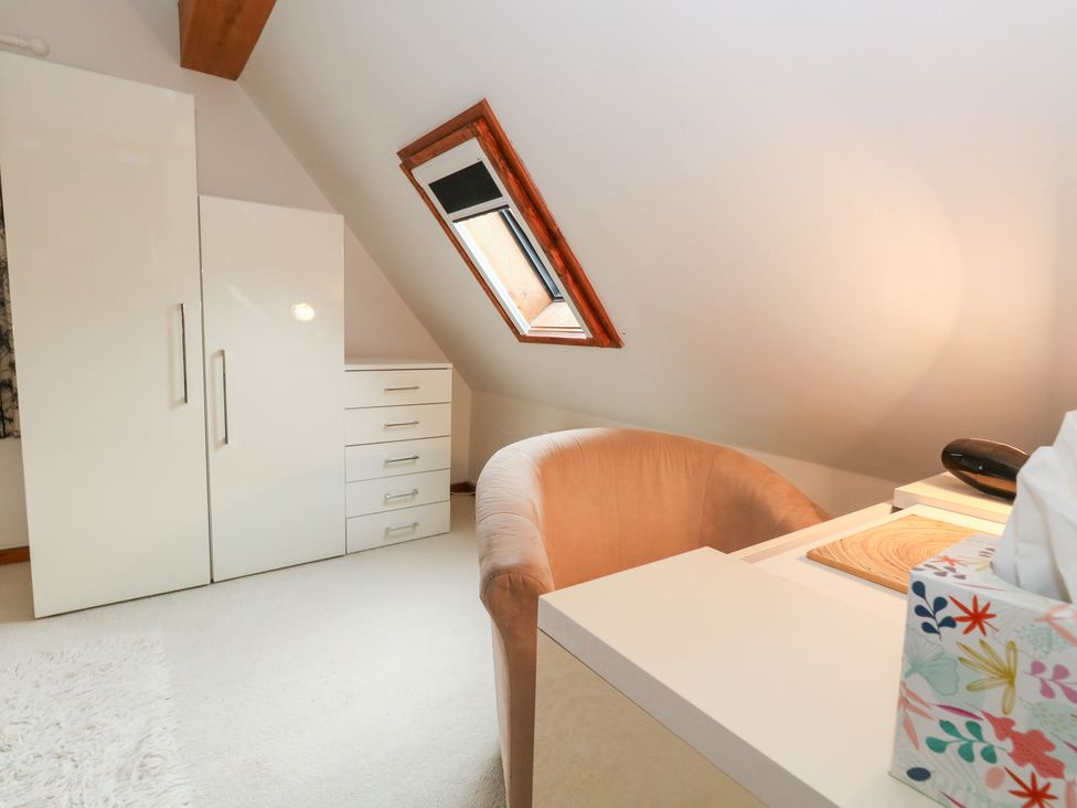 An office with a desk and wardrobe at Bubbs Cottage