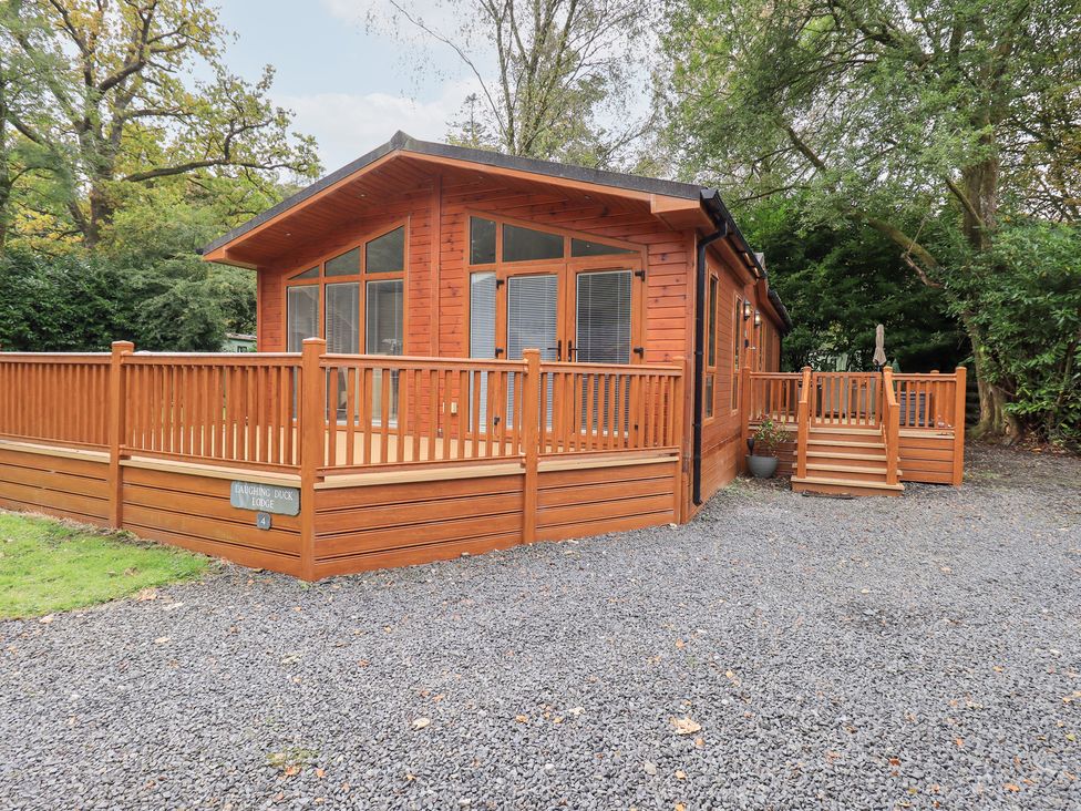 A lodge with decking and steps at Laughing Duck in Troutbeck Bridge