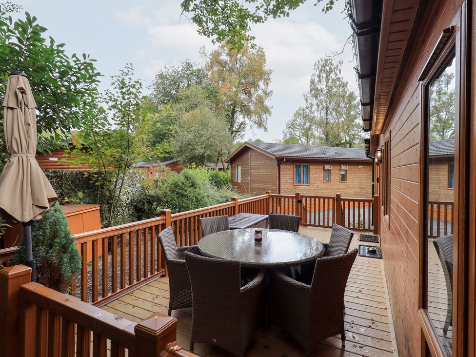 An outdoor patio with a table and chairs at Laughing Duck in Troutbeck Bridge