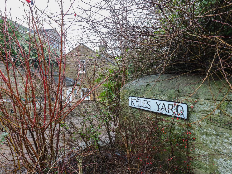 A sign for Kyles Yard with bushes in Barnard Castle