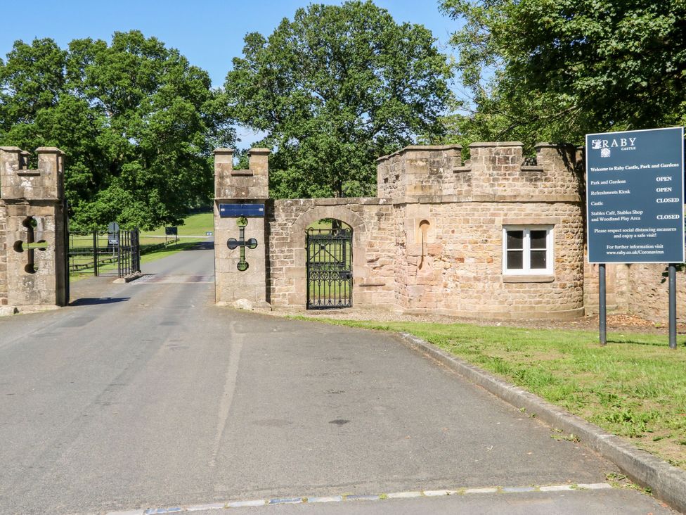 A gate entrance with a sign at Raby Castle in Barnard Castle