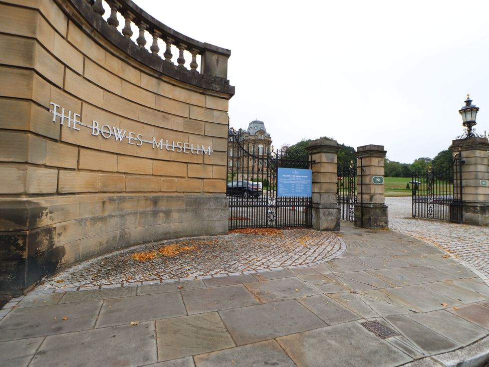 The entrance gate with sign at The Bowes Museum in Barnard Castle