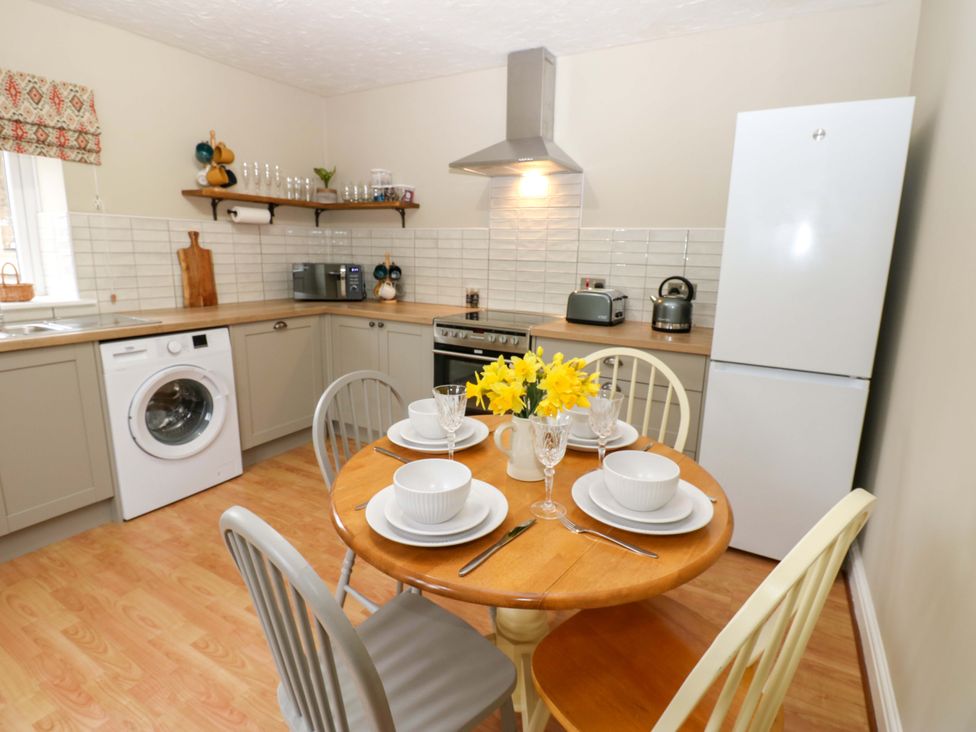 A kitchen with a dining table and chairs at 1 Kyles Yard Barnard Castle