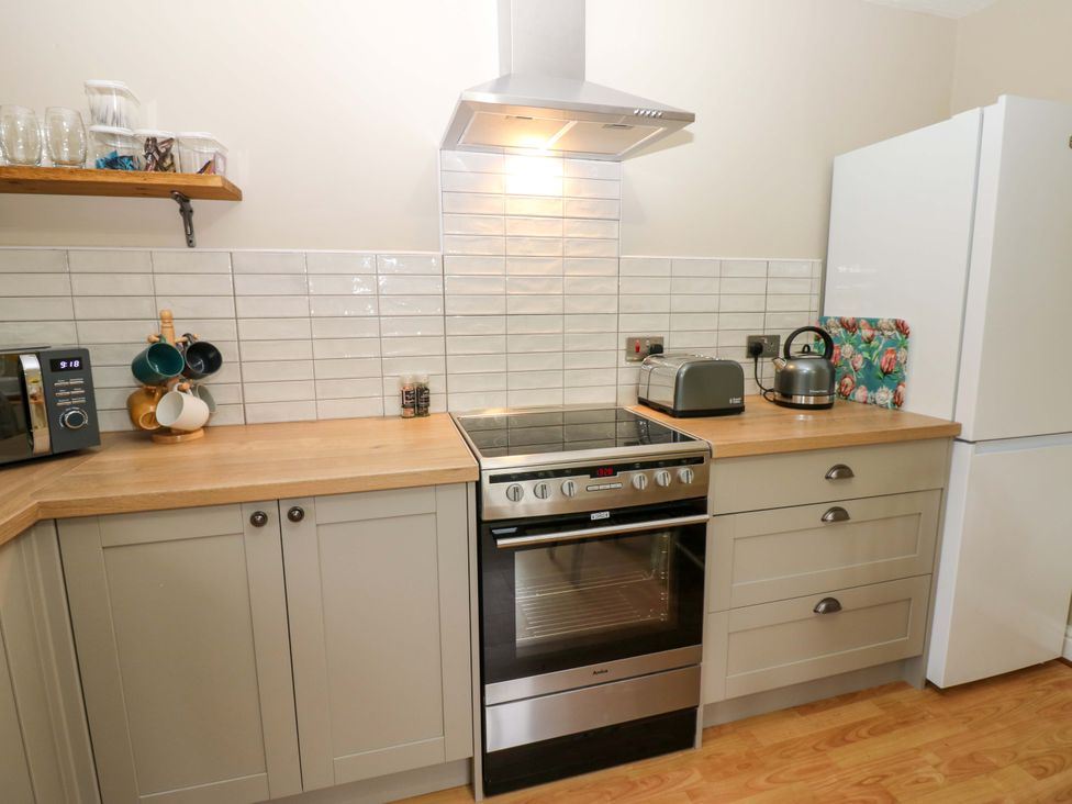 A kitchen with modern appliances and wooden countertops at 1 Kyles Yard Barnard Castle