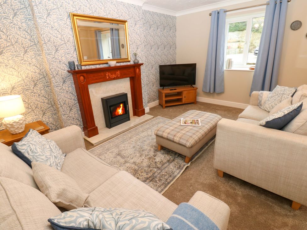 A living room with a fireplace and a television at 1 Kyles Yard Barnard Castle