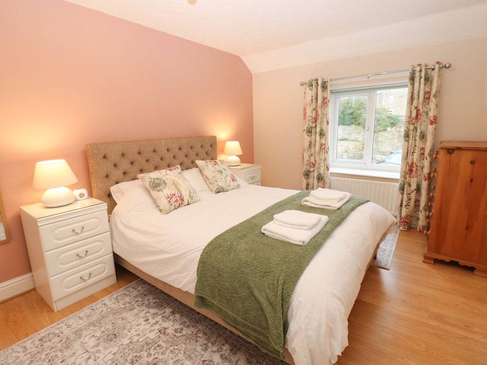 A bedroom with a bed and nightstands at 1 Kyles Yard in Barnard Castle