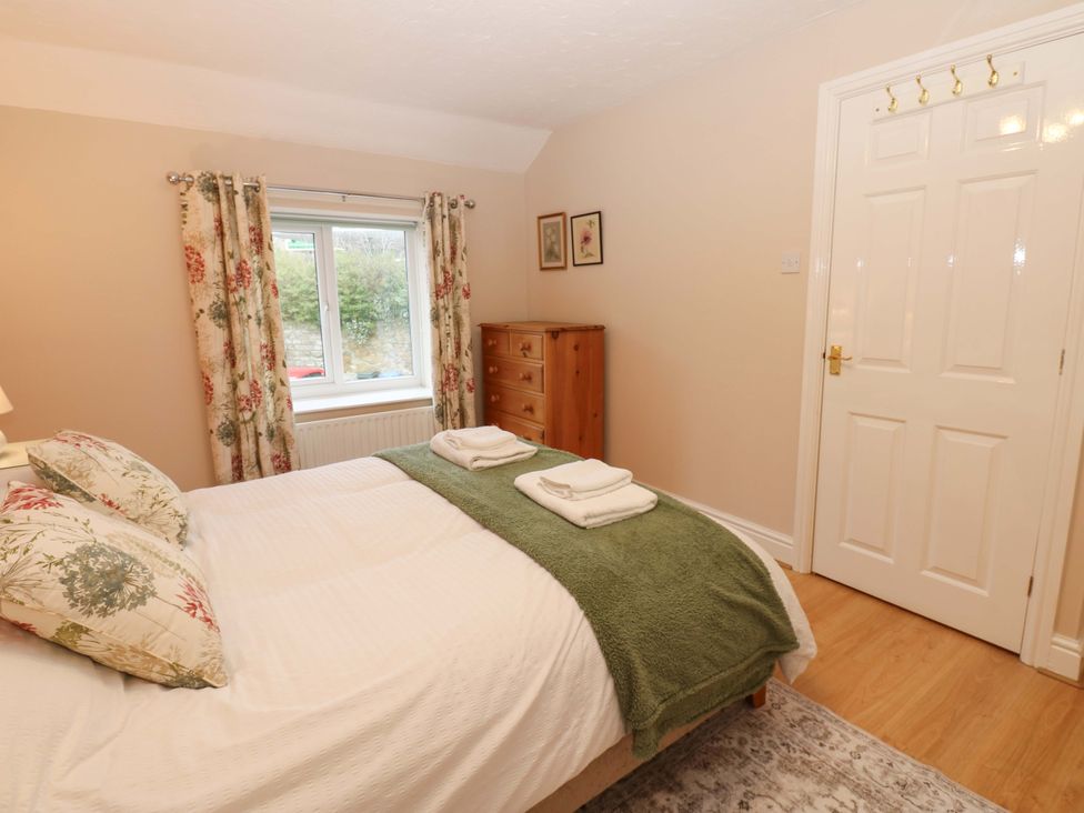 A bedroom with a bed and a dressing table at 1 Kyles Yard in Barnard Castle
