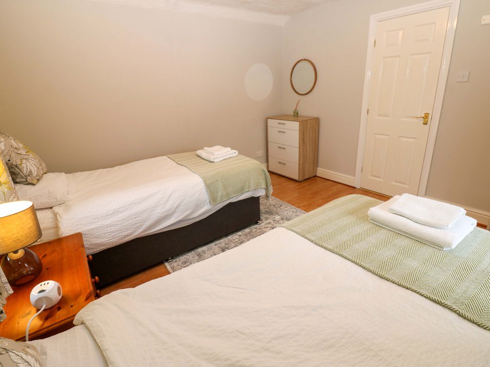 A bedroom with two beds and a dresser at 1 Kyles Yard in Barnard Castle