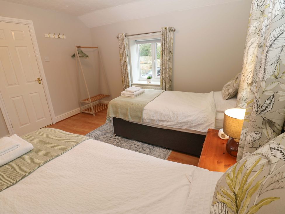 A bedroom with two beds and a window at 1 Kyles Yard Barnard Castle