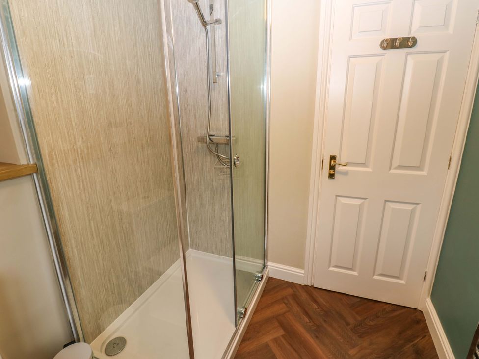 A shower enclosure with a door in a bathroom at 1 Kyles Yard Barnard Castle