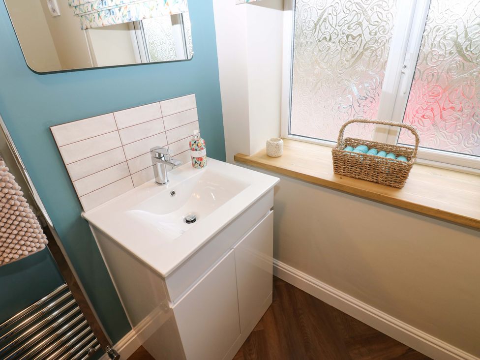 A bathroom with a sink and mirror at 1 Kyles Yard, Barnard Castle