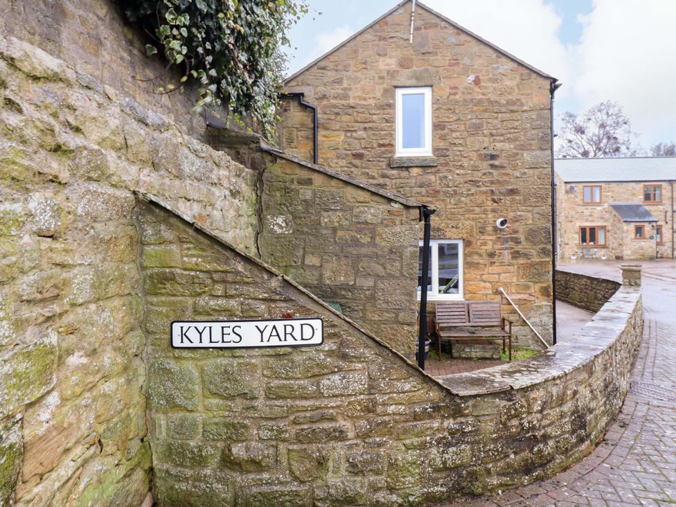 A outdoor area with a sign and a bench at 1 Kyles Yard Barnard Castle