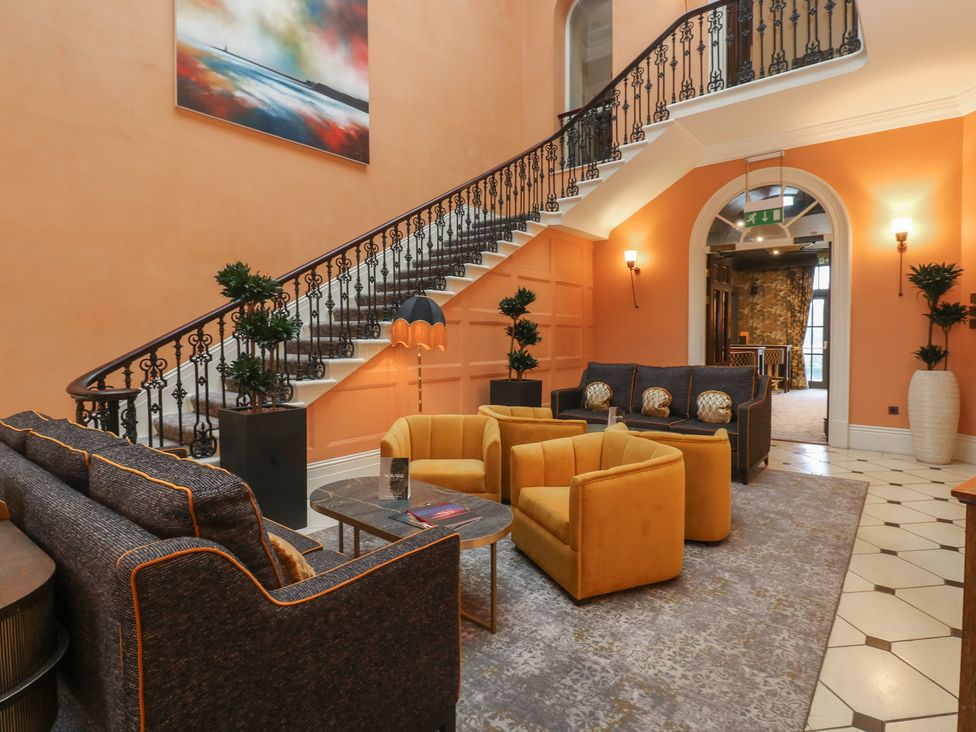 A lobby with a staircase and seating area at Costal Lodge at Seaham Hall Seaham
