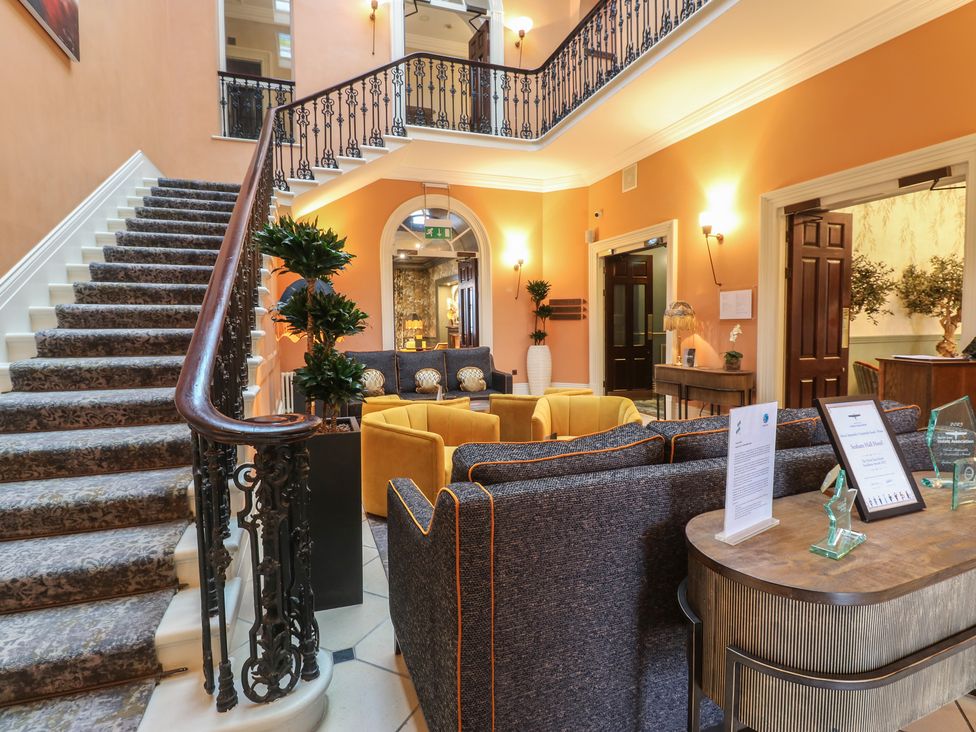 A lobby with a staircase and seating area at Costal Lodge at Seaham Hall Seaham