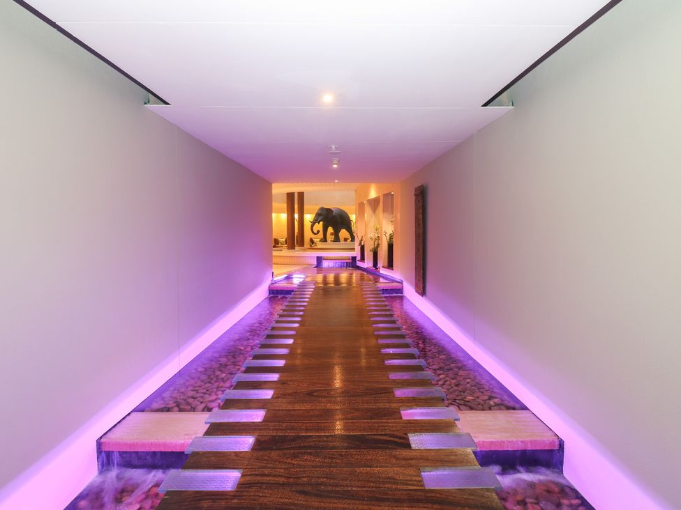 A hallway with a wooden walkway and a sculpture at Costal Lodge at Seaham Hall, Seaham