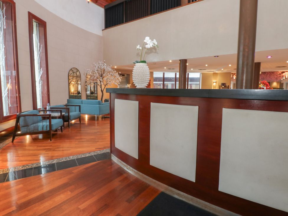 A lobby with a reception desk and seating areas at Costal Lodge at Seaham Hall Seaham