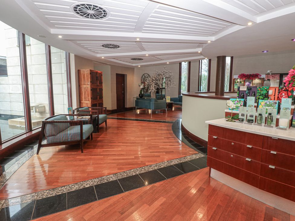 A lobby area with reception desk and seating at Costal Lodge at Seaham Hall Seaham