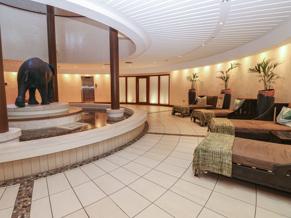 A lobby with an elephant statue and seating area at Coastal Lodge at Seaham Hall