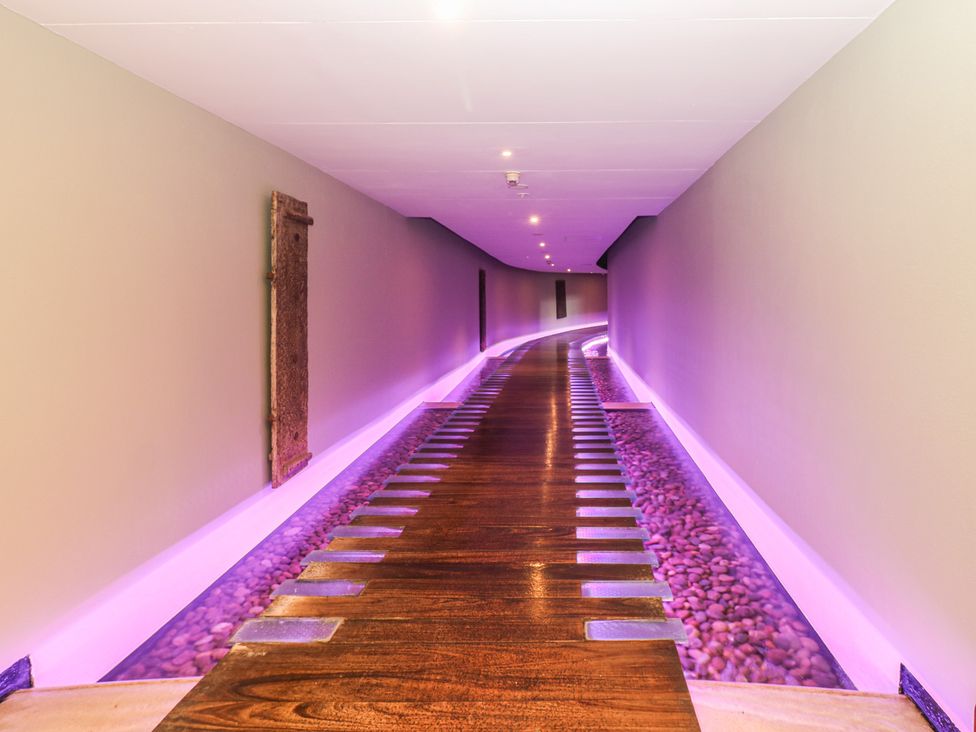A hallway with wooden flooring and pebbles at Costal Lodge at Seaham Hall in Seaham