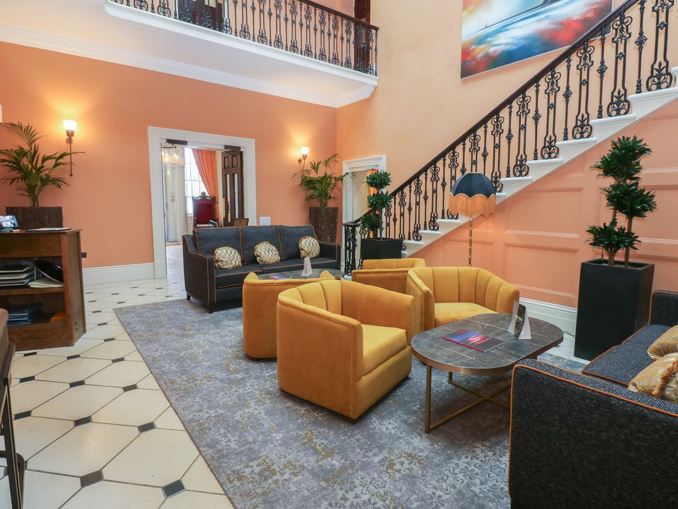 A lobby with seating and a staircase at Costal Lodge at Seaham Hall Seaham