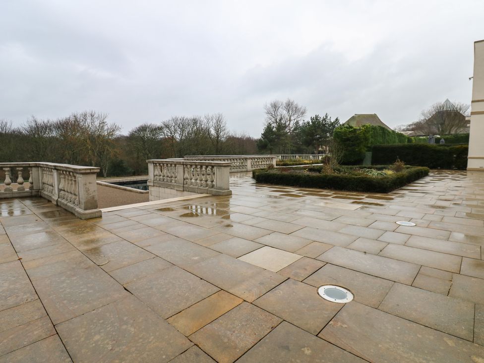 An outdoor area with a stone patio and garden features at Costal Lodge at Seaham Hall Seaham
