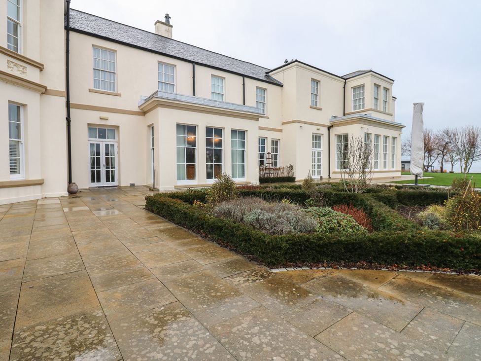 An outdoor view of a house with gardens at Costal Lodge at Seaham Hall Seaham