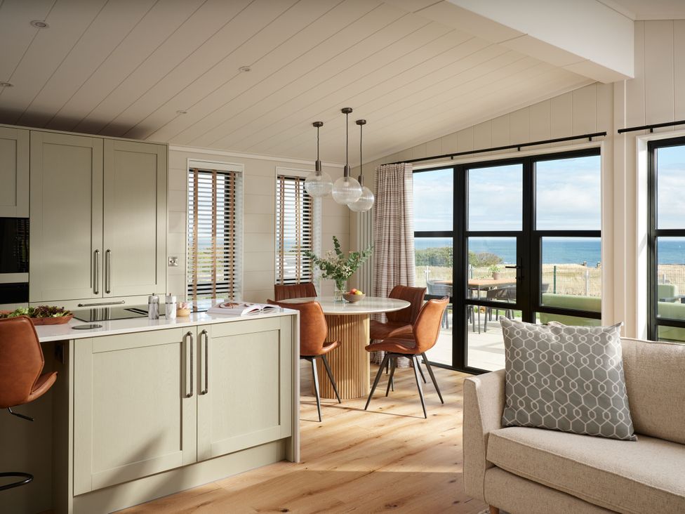 A kitchen with dining area and windows at Costal Lodge at Seaham Hall Seaham