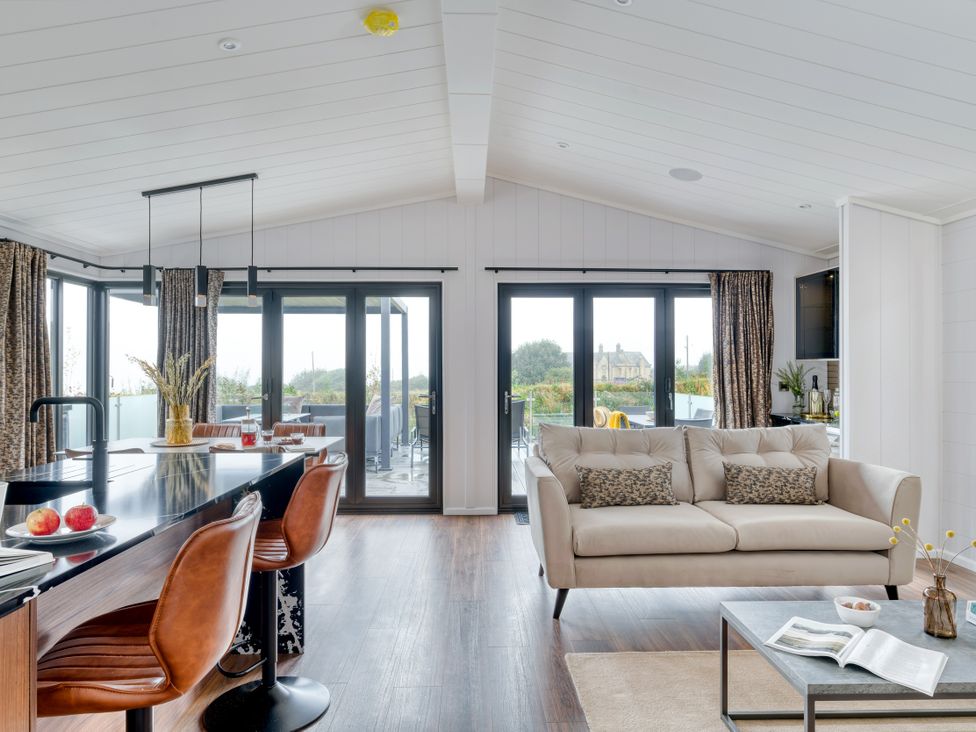 A living room with a sofa and coffee table at Coastal Lodge at Seaham Hall in Seaham