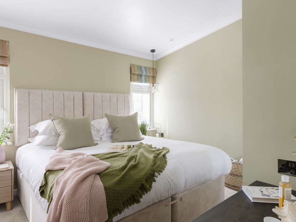 A bedroom with a bed and plant at Costal Lodge at Seaham Hall in Seaham